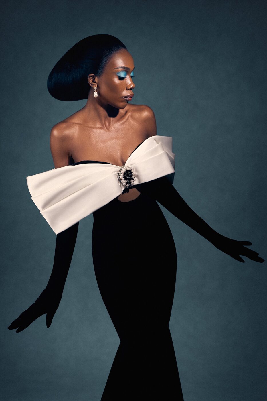 Model in black gown with oversized white bow